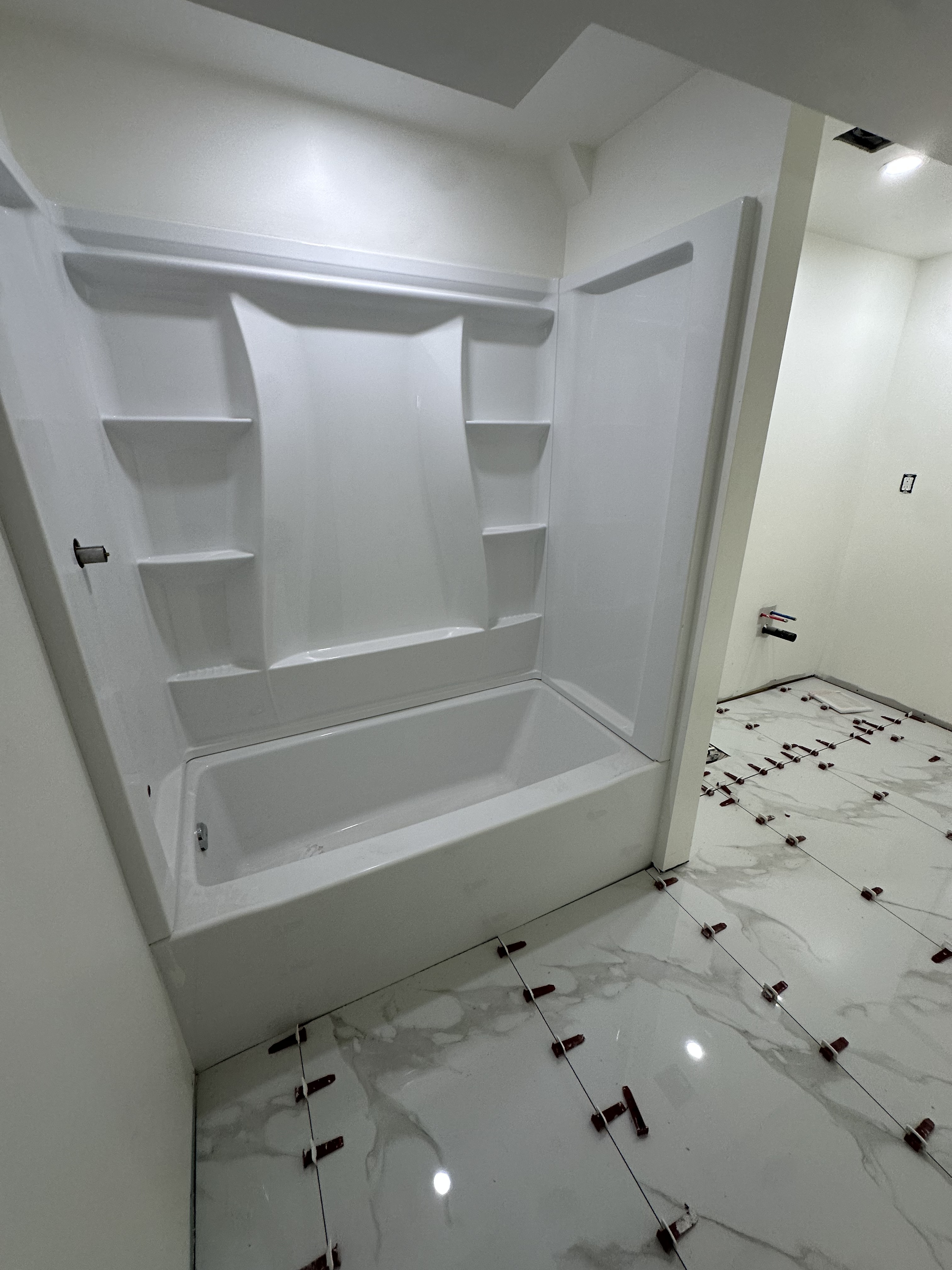 Tub & Marble Floor Tile Installation — Renovations project by Redstone Construction in Brampton, ON