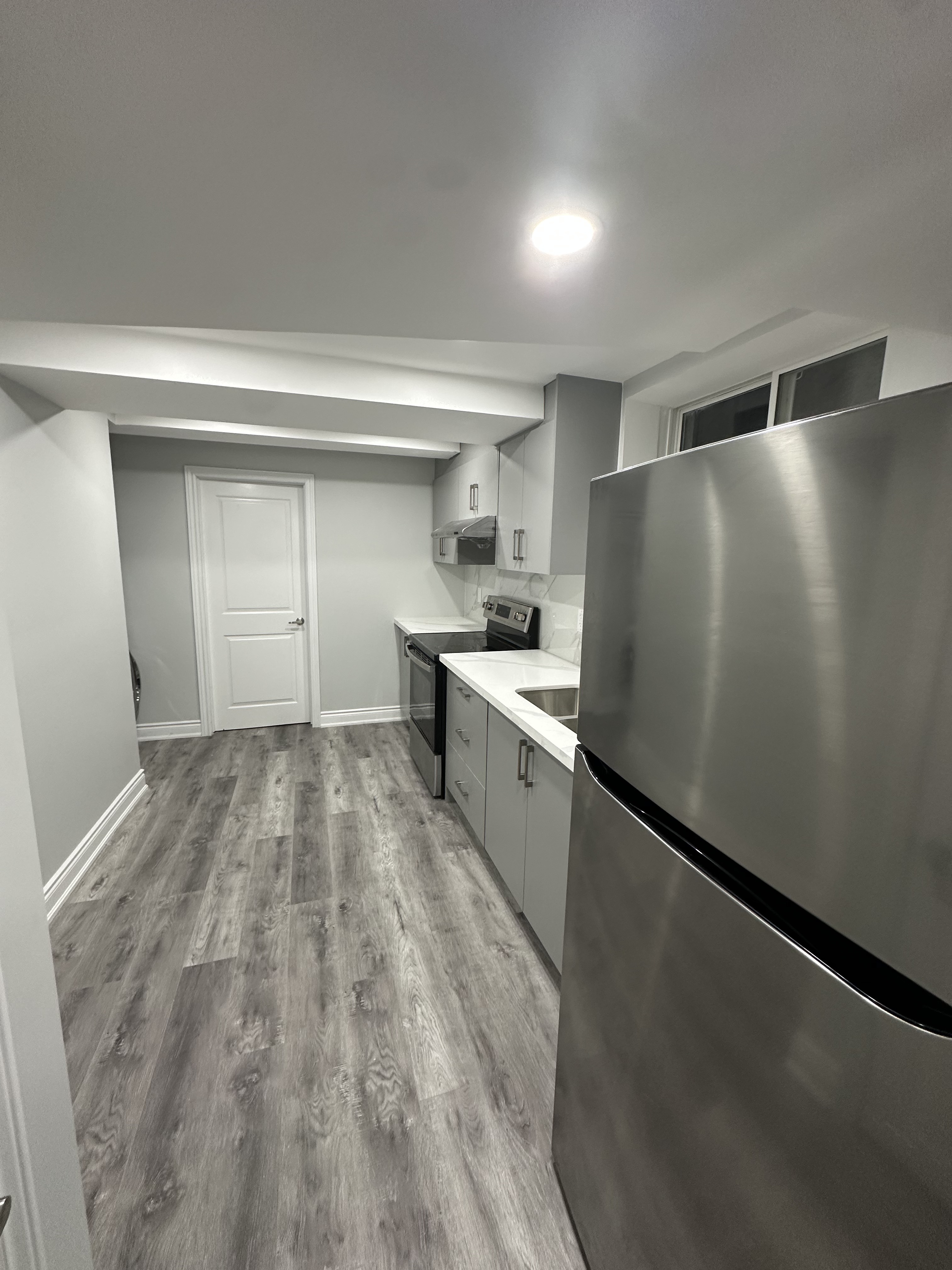 Open-Concept Basement Kitchen & Corridor — Basements project by Redstone Construction in Brampton, ON